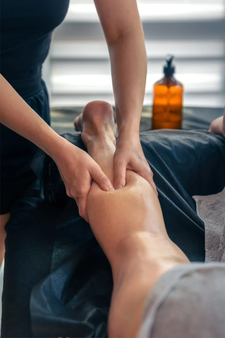 Massage therapist working on a calf muscle